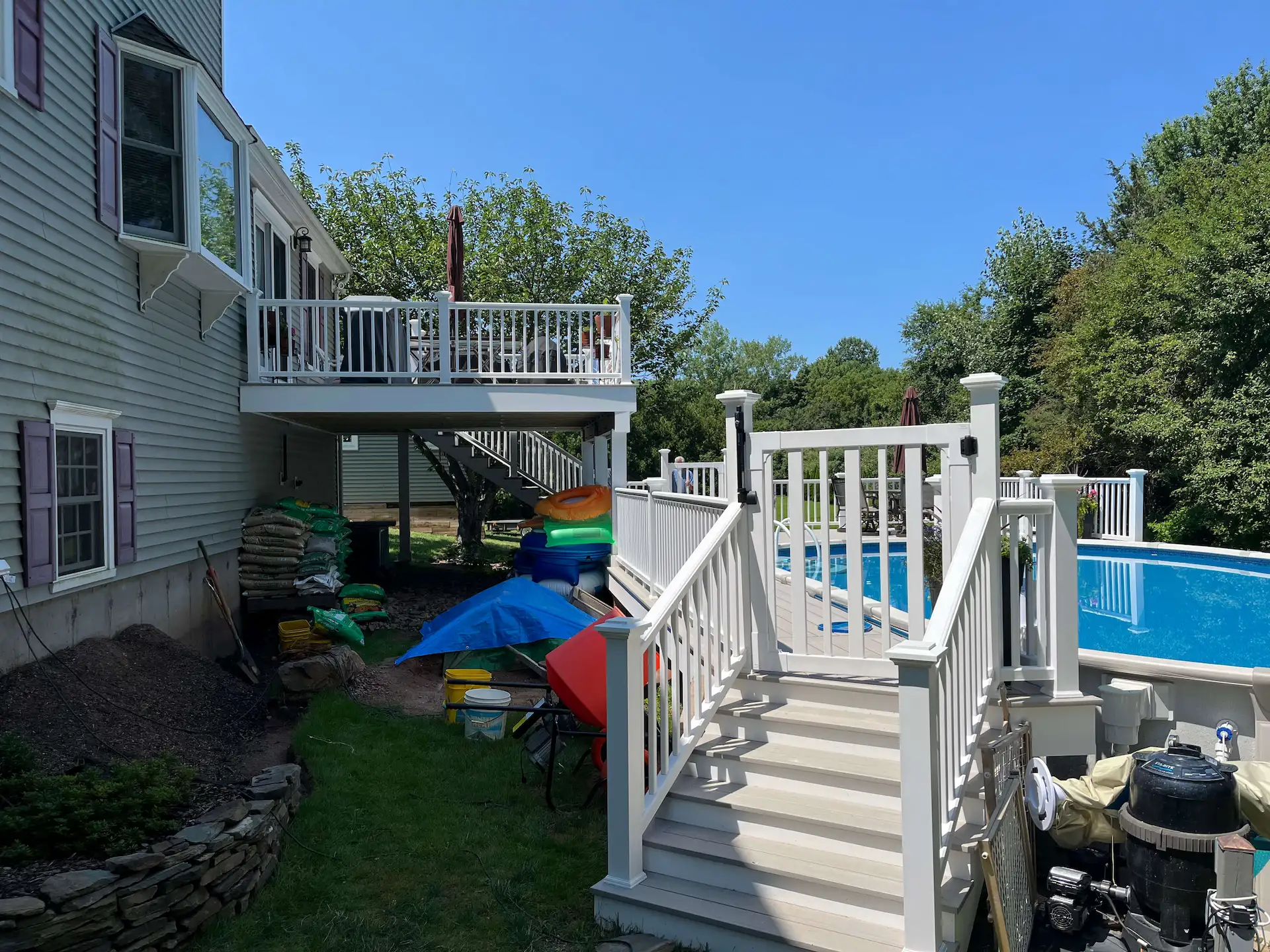 Staged TimberTech PVC pool deck Deck remodeling Deck construction Back yard upgrade Vinyl deck Vinyl decking Composite decking deck builder near me deck contractors near me PT deck with wire rails