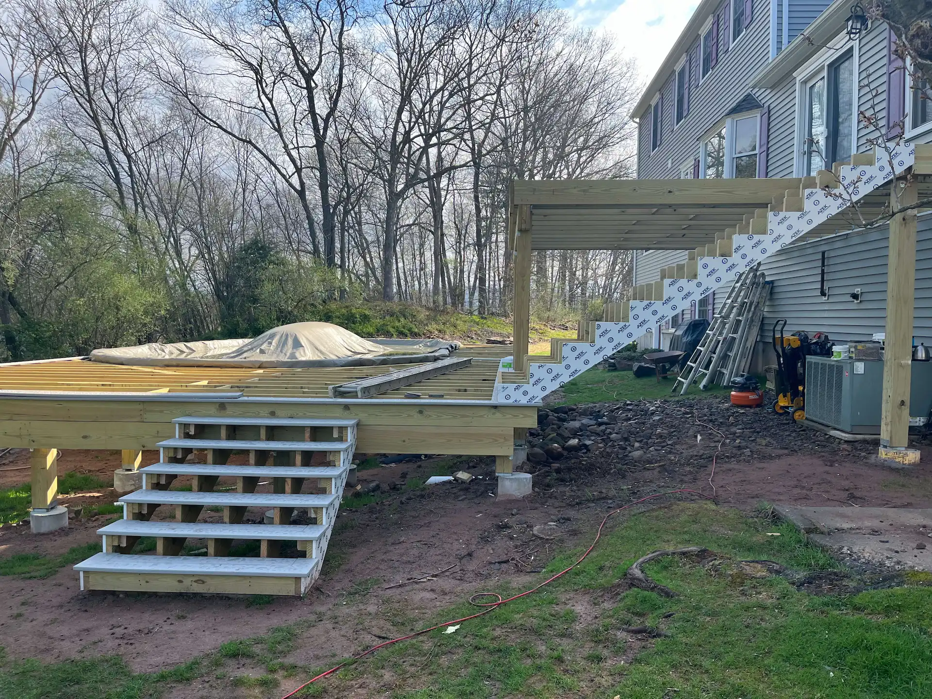 Staged TimberTech PVC pool deck Deck remodeling Deck construction Back yard upgrade Vinyl deck Vinyl decking Composite decking deck builder near me deck contractors near me PT deck with wire rails