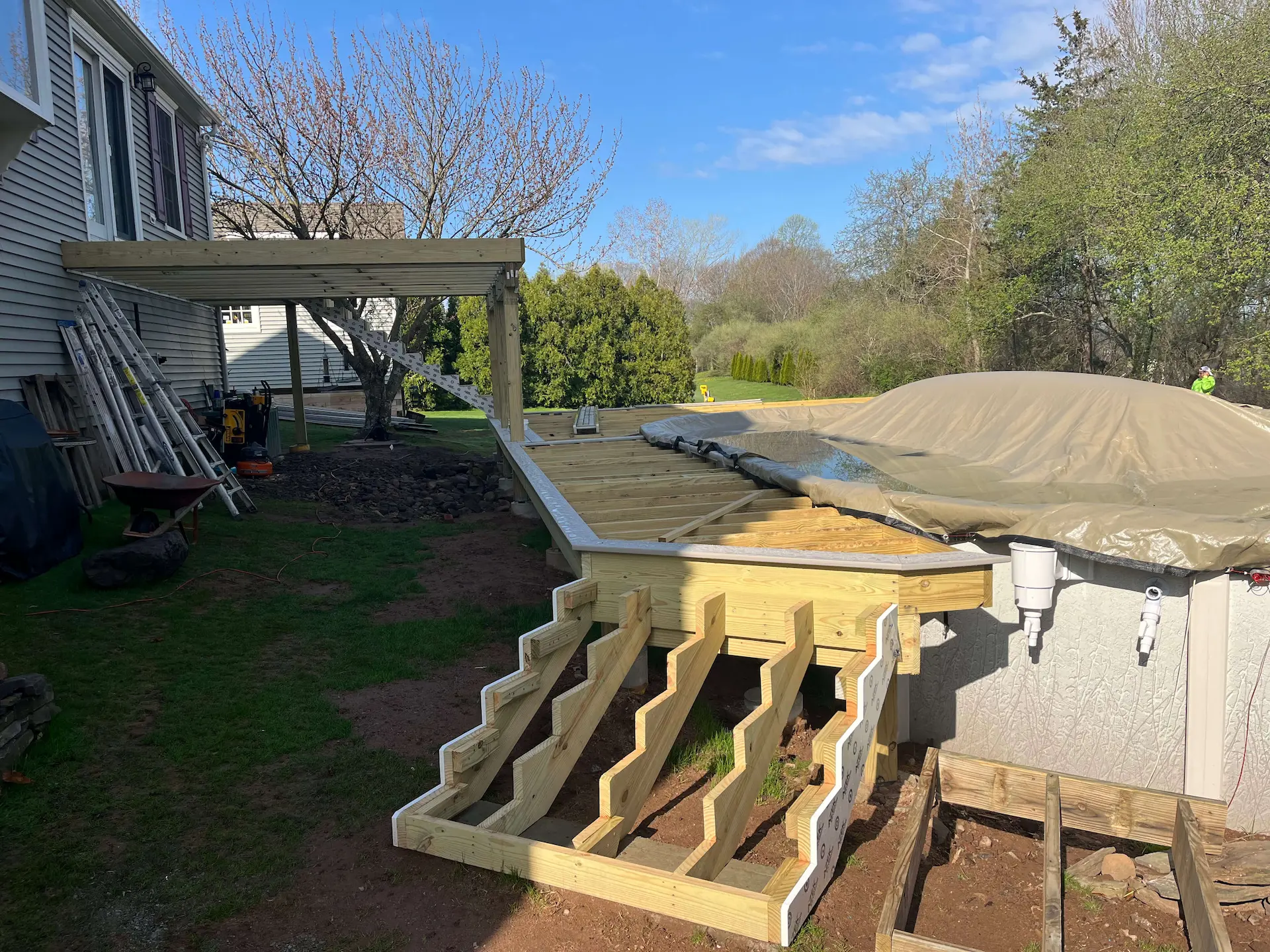 Staged TimberTech PVC pool deck Deck remodeling Deck construction Back yard upgrade Vinyl deck Vinyl decking Composite decking deck builder near me deck contractors near me PT deck with wire rails